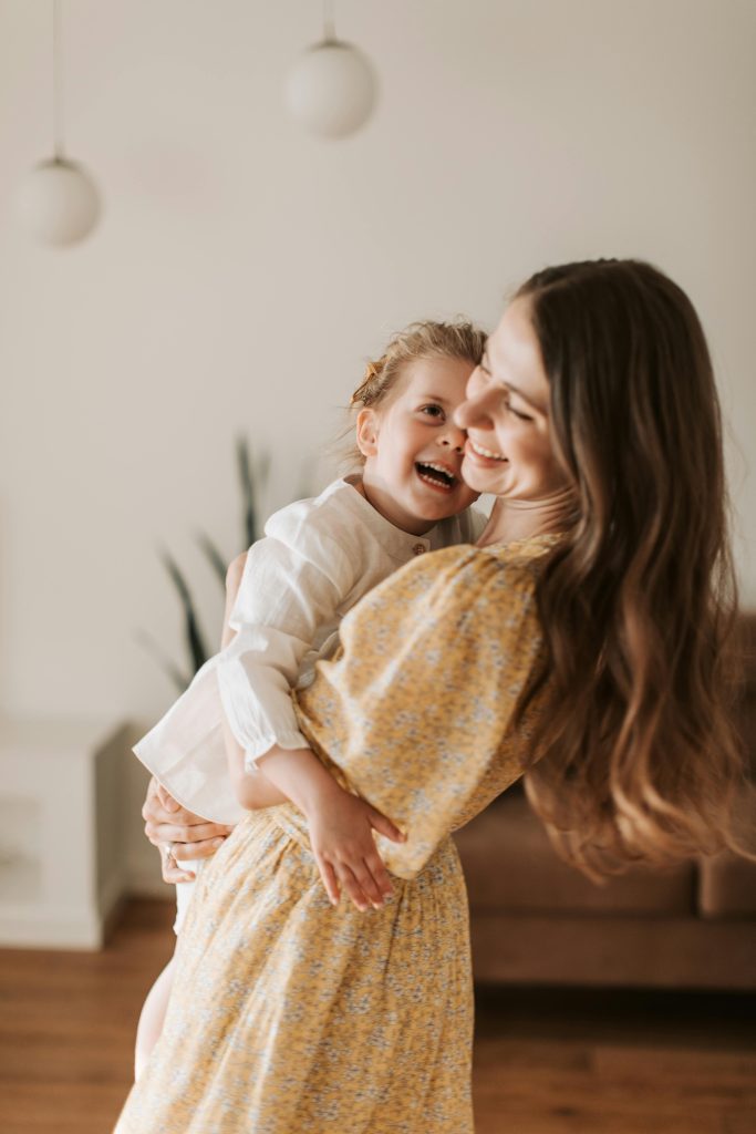 pexels-photo-4609070-4609070 A happy mother and daughter sharing a joyful moment together in a cozy home setting.